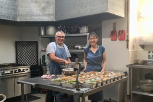 Luis and Marie preparing food for the homeless