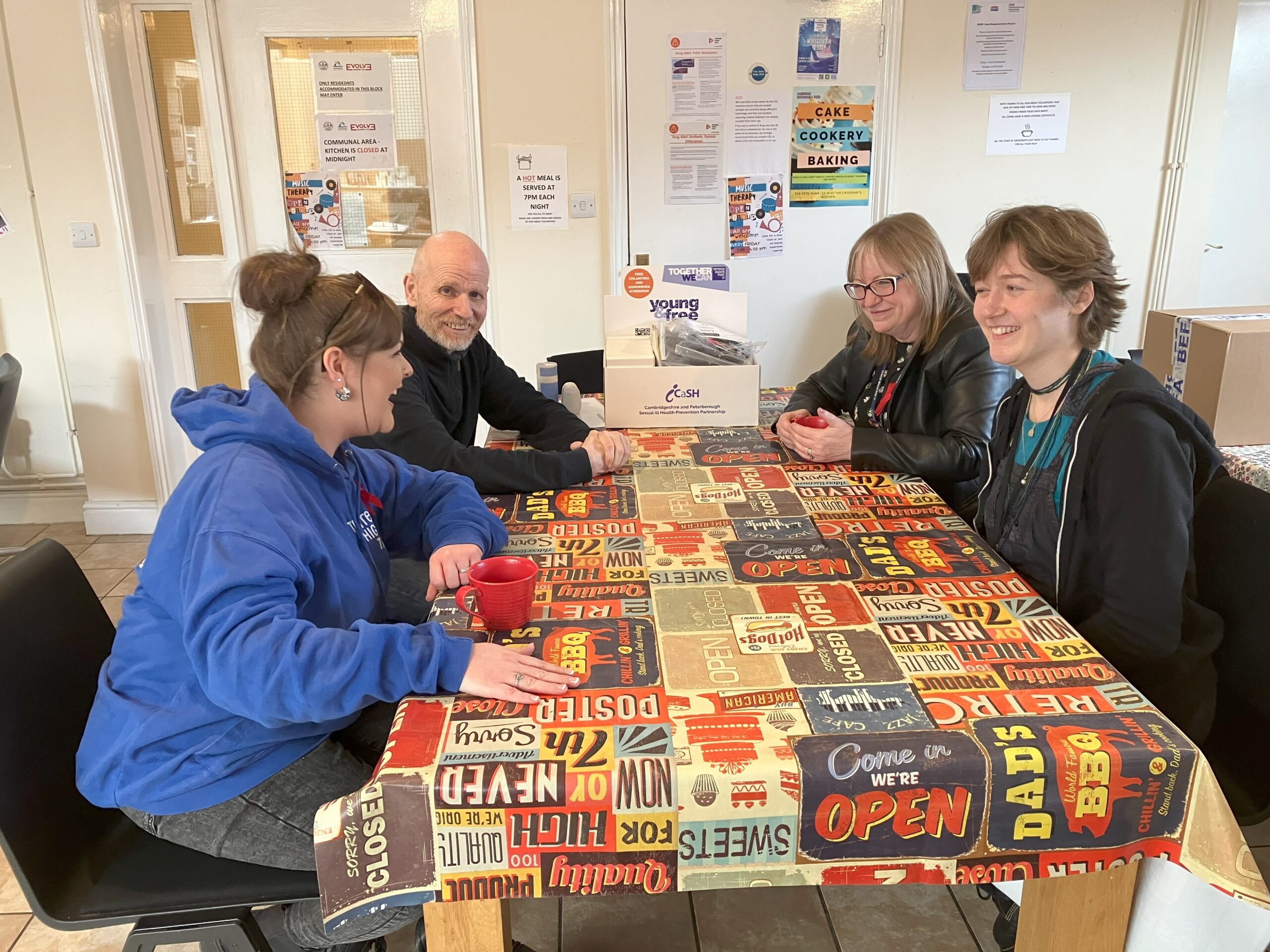 Four people sit around the table in Crossways dining room