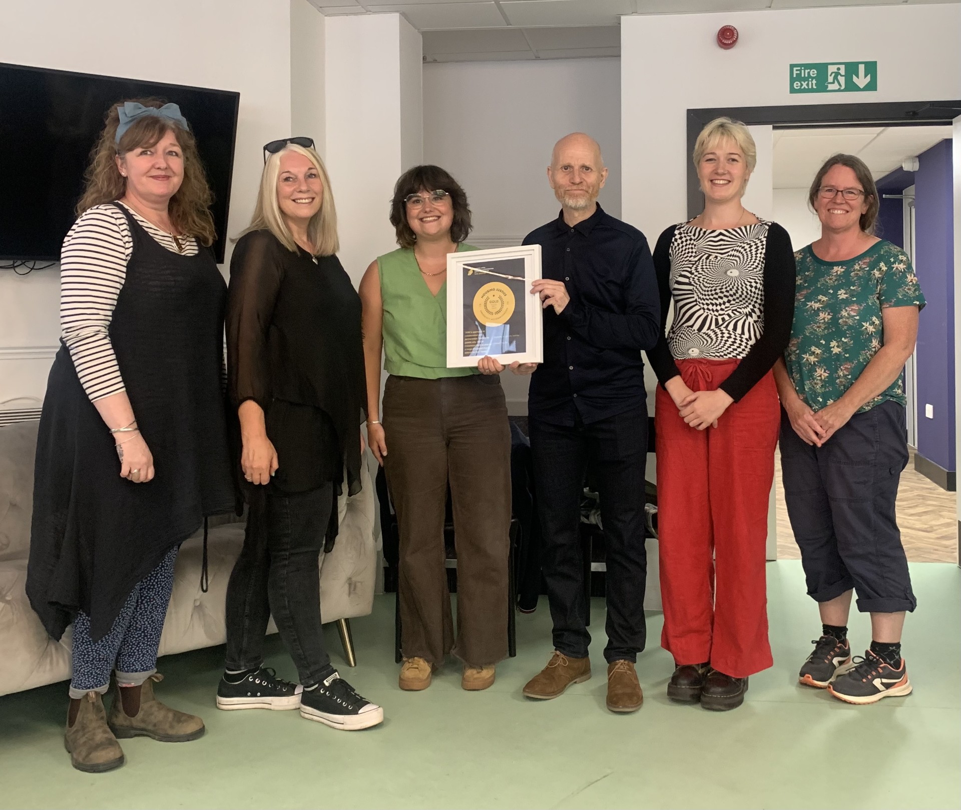 Emma Rule, along with other ITAC staff receiving Housing Justice Gold Mark Award