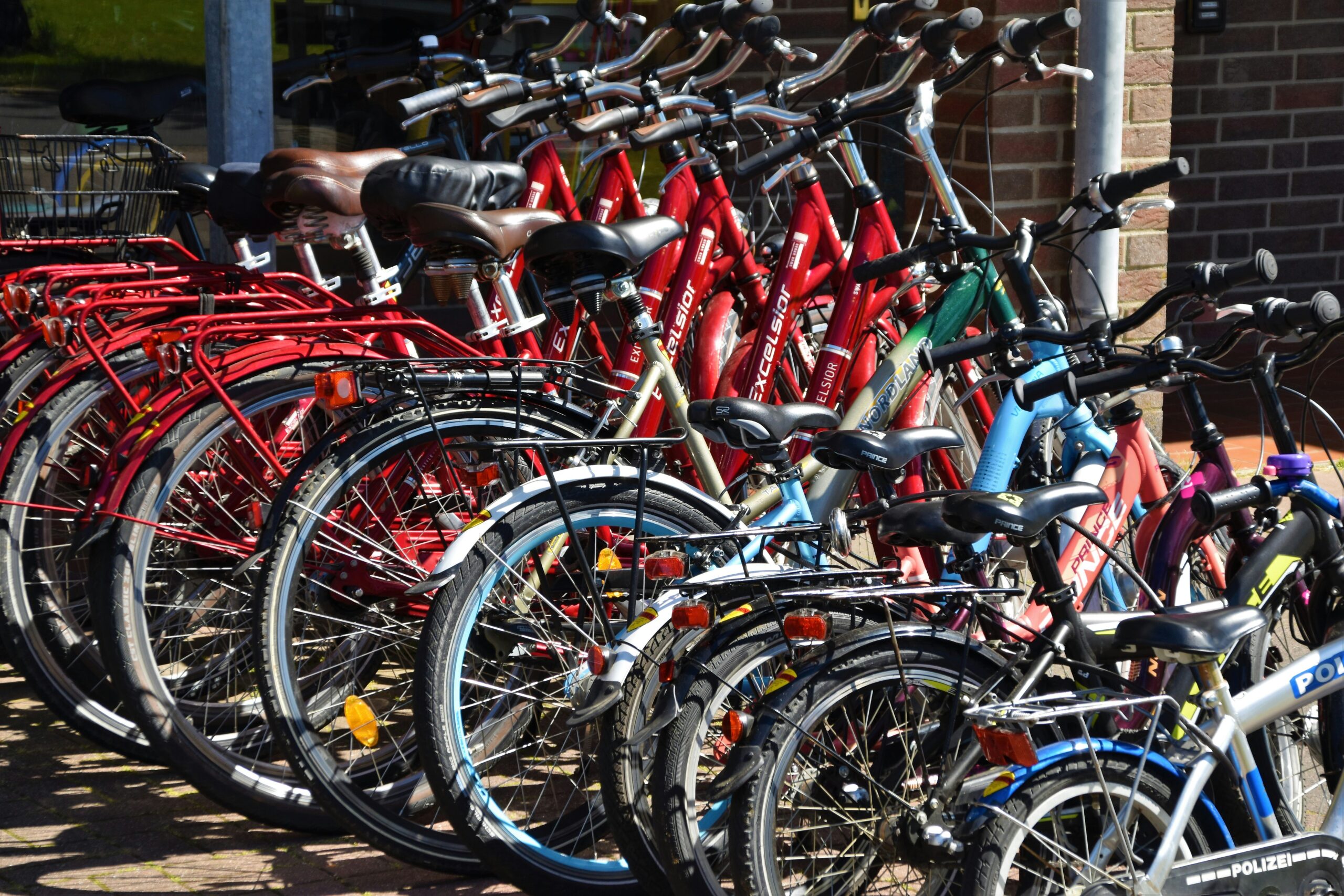 waldemar-brandt-6pRIXT8EcSI-unsplash Bicycles of various sizes lined up in a rack