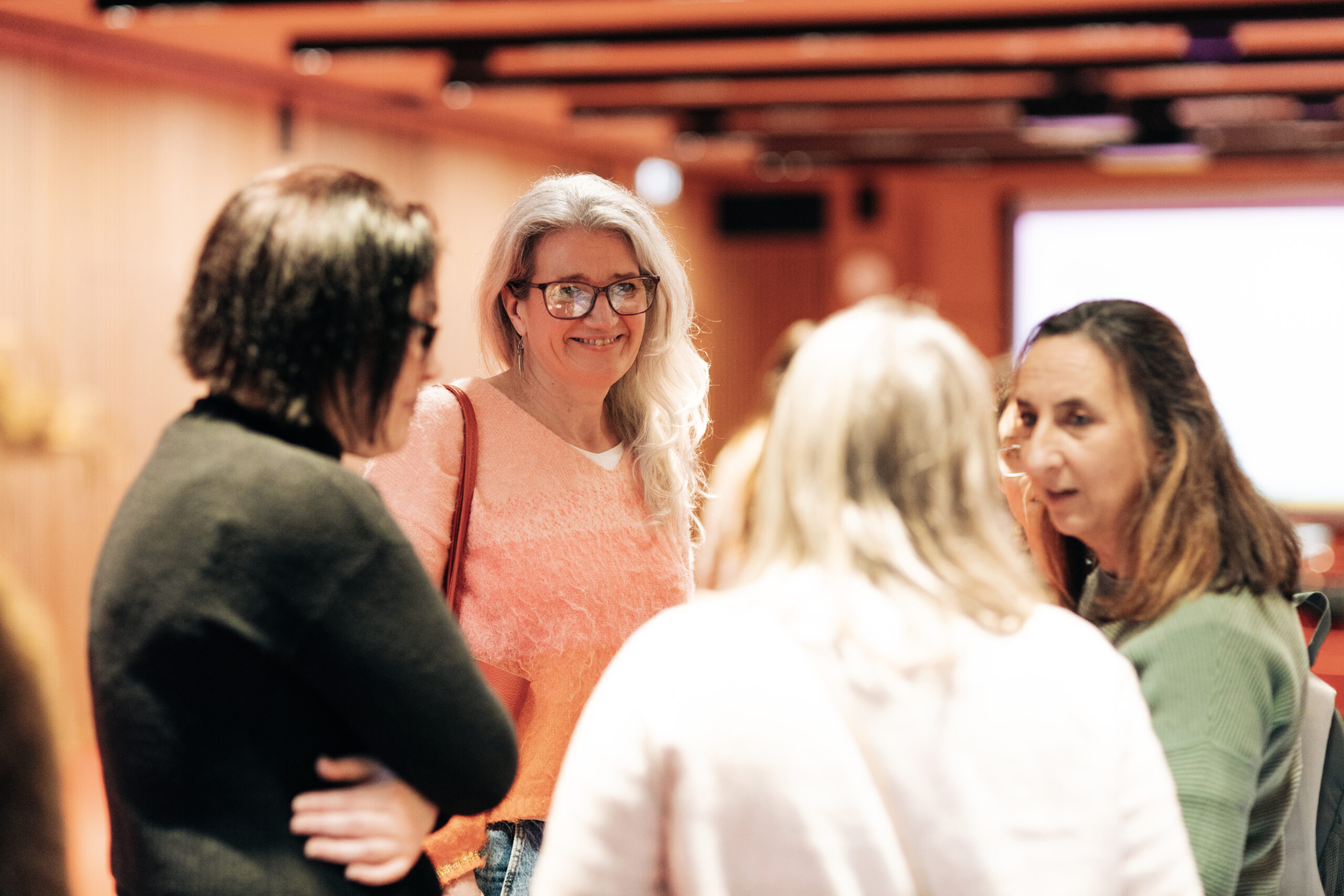 Claire listening to attendees at Embrace event